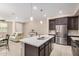 Open kitchen and living room area with an island, stainless steel appliances, and neutral tones at 2631 S Sulley Dr # 104, Gilbert, AZ 85295