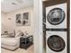 Convenient laundry area featuring stacked washer and dryer, seamlessly integrated next to a comfortable living space at 2631 S Sulley Dr # 104, Gilbert, AZ 85295