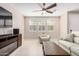 Bright living room with tile flooring, a ceiling fan, and a comfortable seating area at 2631 S Sulley Dr # 104, Gilbert, AZ 85295