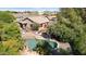 Aerial shot of the house, pool, lush landscaping, and outdoor seating area at 28814 N 45Th St, Cave Creek, AZ 85331
