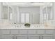 Bathroom featuring dual sinks, white cabinets, and decorative accents at 28814 N 45Th St, Cave Creek, AZ 85331