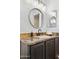 Bathroom featuring granite counter, black fixtures, decorative soap, and dual mirrors at 28814 N 45Th St, Cave Creek, AZ 85331