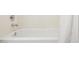 Plain white bathtub with striped white shower curtain and chrome faucet at 28814 N 45Th St, Cave Creek, AZ 85331