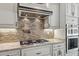 Gourmet kitchen with stainless steel appliances, hood range, and stylish backsplash at 28814 N 45Th St, Cave Creek, AZ 85331