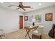 Well-lit office with wood floors, desk, ceiling fan, and view to the exterior at 28814 N 45Th St, Cave Creek, AZ 85331