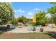 Backyard pool area with beautiful plants and trees, outdoor seating, and rock features at 28814 N 45Th St, Cave Creek, AZ 85331