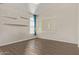 This bright bedroom offers wood-look flooring, a modern light fixture, and a window at 3109 N Meadow Dr, Avondale, AZ 85392