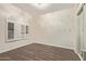 Clean, bright bedroom with hardwood floors, white trim, and a large window, creating a relaxing atmosphere at 3109 N Meadow Dr, Avondale, AZ 85392