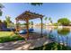 Beautiful community lake featuring a wooden pergola, boat access, and scenic views, enhancing the community's appeal at 3109 N Meadow Dr, Avondale, AZ 85392