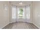 Bright dining area with large window, sheer white curtains, and modern light fixture at 3109 N Meadow Dr, Avondale, AZ 85392
