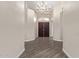 Entryway with gray wood floors, neutral walls, and modern chandelier at 3109 N Meadow Dr, Avondale, AZ 85392