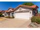 Charming single-Gathering home featuring a well-manicured lawn, a two-car garage, and a beautiful orange tile roof at 3109 N Meadow Dr, Avondale, AZ 85392