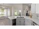 Bright kitchen featuring white countertops, stainless steel sink, and view of the backyard and waterway at 3109 N Meadow Dr, Avondale, AZ 85392