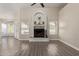Spacious living room with fireplace, gray wood floors, and lots of natural light at 3109 N Meadow Dr, Avondale, AZ 85392