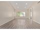 Open living room featuring gray wood floors, neutral walls, and large window at 3109 N Meadow Dr, Avondale, AZ 85392