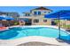 Spacious backyard featuring a sparkling pool, lush landscaping, and a well-maintained two-story home at 3247 E Creosote Ln, Gilbert, AZ 85298