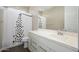 Bathroom with decorative shower curtain, single vanity sink and mirror at 3247 E Creosote Ln, Gilbert, AZ 85298