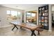 Bright dining room with a large wooden table, stylish decor, and sliding doors leading to the backyard patio at 3247 E Creosote Ln, Gilbert, AZ 85298