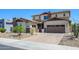 Beautiful two-story home with a three-car garage and well-maintained desert landscaping, enhancing curb appeal at 3247 E Creosote Ln, Gilbert, AZ 85298