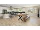 Modern kitchen with stainless appliances, a large island with bar stools, and a dining table at 3247 E Creosote Ln, Gilbert, AZ 85298