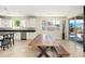 Kitchen and dining area with hardwood floors, stainless steel appliances, and a large dining table at 3247 E Creosote Ln, Gilbert, AZ 85298