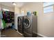 Laundry room with front loading washer and dryer and shoe rack at 3247 E Creosote Ln, Gilbert, AZ 85298