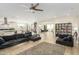 Open-concept living area with hardwood floors, comfortable sofas, and plenty of natural light at 3247 E Creosote Ln, Gilbert, AZ 85298
