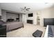 Spacious carpeted main bedroom with ceiling fan, desk, TV, black dresser and piano at 3247 E Creosote Ln, Gilbert, AZ 85298