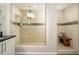 Shower with glass door, tan tiling, bench seating, shelving and window at 3247 E Creosote Ln, Gilbert, AZ 85298