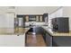 This kitchen showcases stainless appliances, black cabinets, and granite countertops at 351 N Danyell Dr, Chandler, AZ 85225