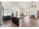 Open-concept kitchen features granite island, black cabinetry, and flows into the dining area at 351 N Danyell Dr, Chandler, AZ 85225