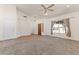 Bright living room featuring carpet flooring, a ceiling fan, and a large window with neighborhood views at 351 N Danyell Dr, Chandler, AZ 85225