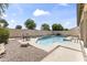 Backyard oasis featuring a sparkling pool with a small waterfall and a charming outdoor seating area at 351 N Danyell Dr, Chandler, AZ 85225