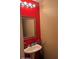 Bathroom with pedestal sink, statement wall and good lighting at 41228 W Little Dr, Maricopa, AZ 85138