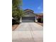 Single story home featuring a two car garage and a low maintenance yard at 41228 W Little Dr, Maricopa, AZ 85138