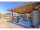 Backyard boasts a covered patio, an outdoor kitchen, and a well-manicured lawn for outdoor enjoyment at 43822 W Baker Dr, Maricopa, AZ 85138