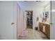 Spacious bathroom features dual sinks, wood cabinets, and access to a closet at 43822 W Baker Dr, Maricopa, AZ 85138