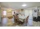 Open-concept dining area with modern decor and an adjacent living room at 43822 W Baker Dr, Maricopa, AZ 85138