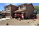 A two-story home with tile roof, minimal landscaping, and a light stucco exterior in a desert environment at 43822 W Baker Dr, Maricopa, AZ 85138