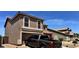 Front exterior of a two-story stucco home showcasing arched windows, a tile roof and two car garage at 43822 W Baker Dr, Maricopa, AZ 85138