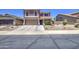 Attractive home with a two-car garage, desert landscaping, and covered entryway at 43822 W Baker Dr, Maricopa, AZ 85138