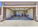 Spacious two-car garage featuring ample storage and a rear entry door at 43822 W Baker Dr, Maricopa, AZ 85138