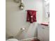 Well-maintained half bathroom with a white vanity and decorative red accents at 43822 W Baker Dr, Maricopa, AZ 85138