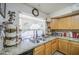 Bright kitchen featuring wood cabinets, granite countertops, and a double sink at 43822 W Baker Dr, Maricopa, AZ 85138