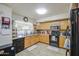 Well-lit kitchen with wood cabinets, granite countertops, and modern appliances at 43822 W Baker Dr, Maricopa, AZ 85138