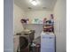 Convenient laundry room with modern washer and dryer and ample shelving at 43822 W Baker Dr, Maricopa, AZ 85138