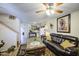 Cozy living room with a ceiling fan, stylish furniture, and hardwood floors at 43822 W Baker Dr, Maricopa, AZ 85138