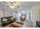 Cozy living room and dining area in an open layout with a ceiling fan and lots of natural light at 43822 W Baker Dr, Maricopa, AZ 85138