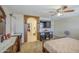 The main bedroom features carpeted floors, an arched doorway to the bathroom, and a ceiling fan for comfort at 43822 W Baker Dr, Maricopa, AZ 85138