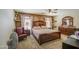 This primary bedroom boasts a luxurious, oversized bed, complementing decor, and a ceiling fan for added comfort at 43822 W Baker Dr, Maricopa, AZ 85138
